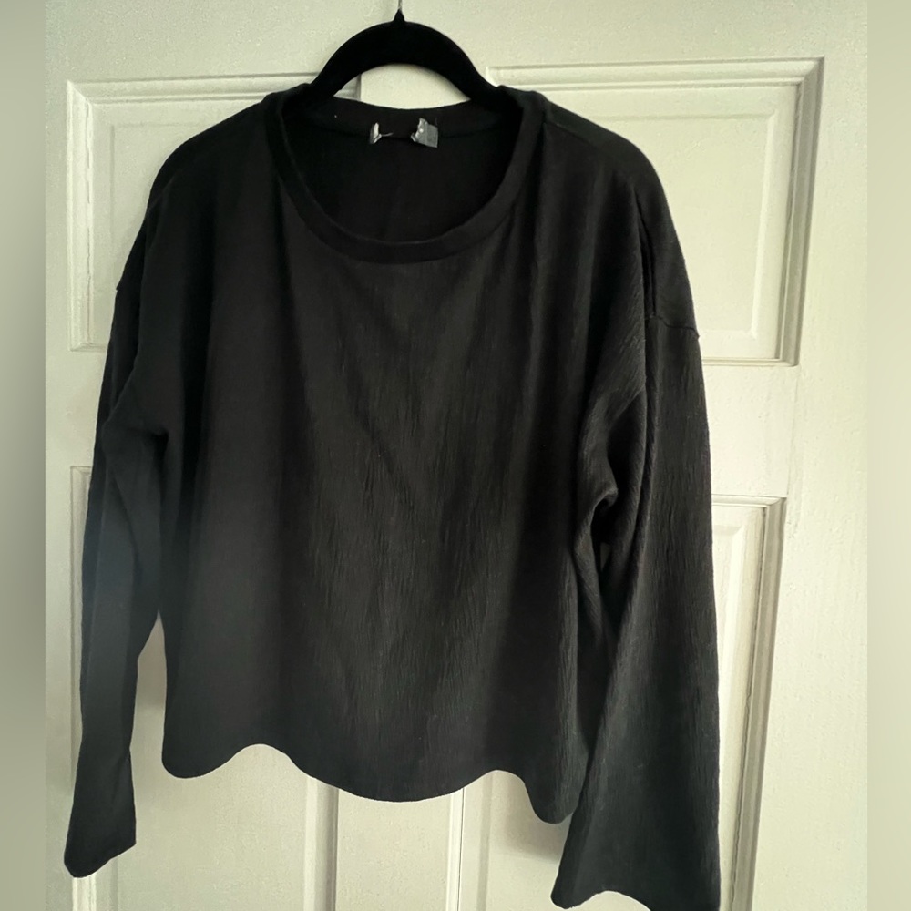 Semi-cropped black, textured long sleeve shirt.